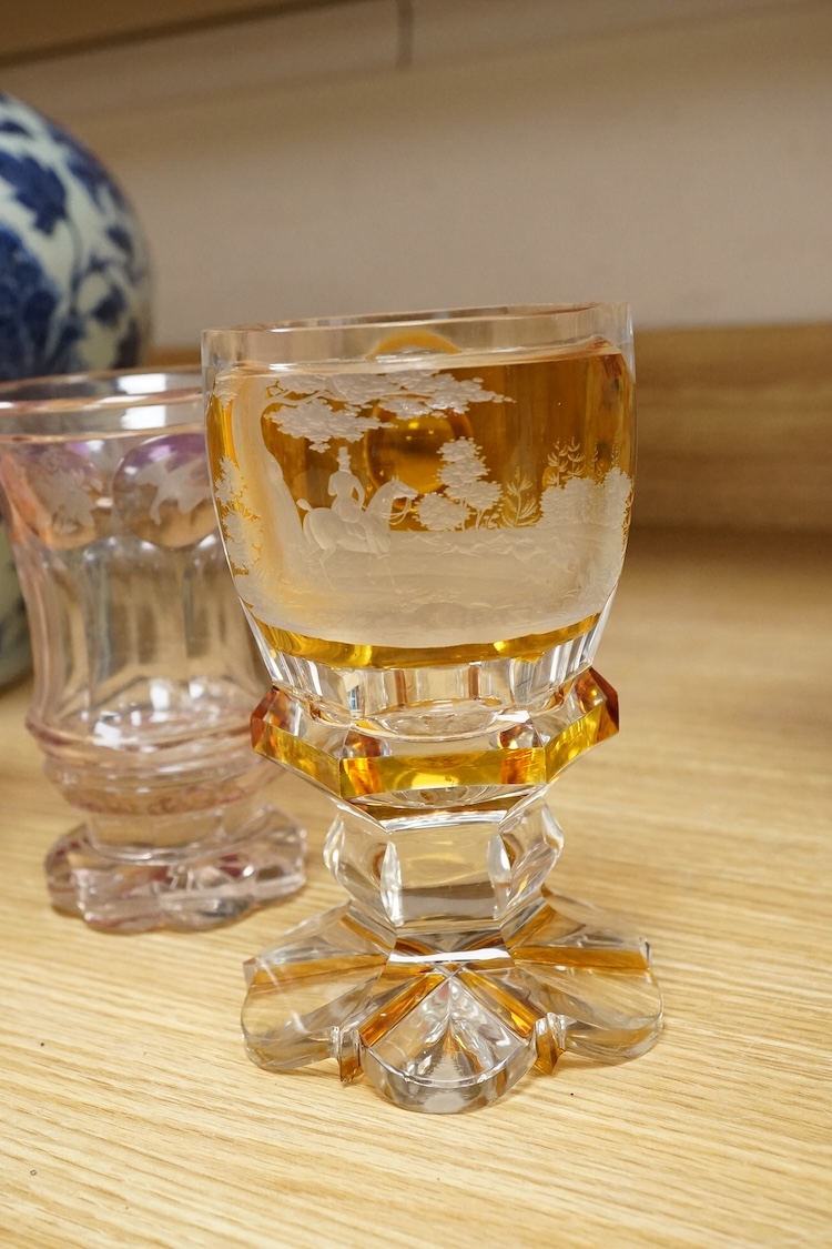 Three Bohemian colour flashed glass goblets, late 19th century, two with hunting subjects, the third decorated with insects, birds and flowers